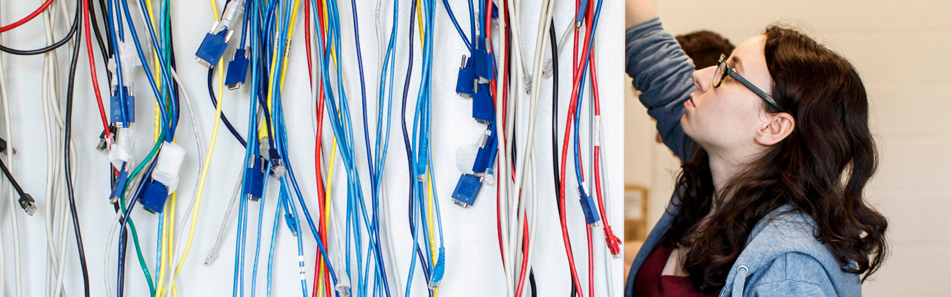 computer networking student working with coloured wires