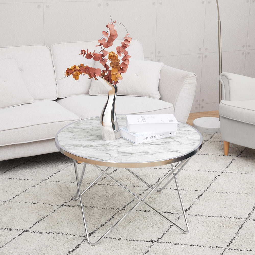 A durable Teamson Home Margo Small Round Faux White Carrara Marble Coffee Table in a living room.