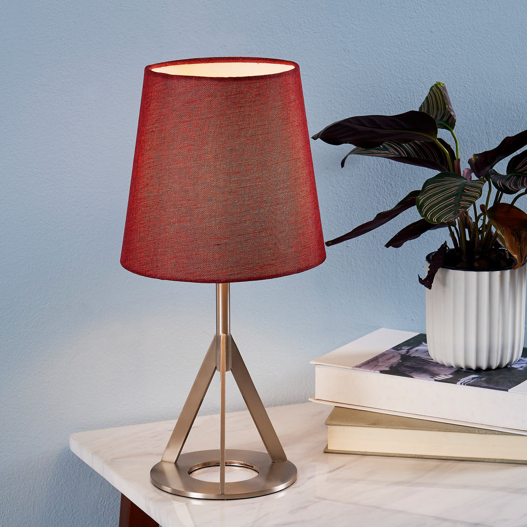 A Teamson Home Aria 15" Modern Table Lamp with Round Red Shade and a geometric nickel base.