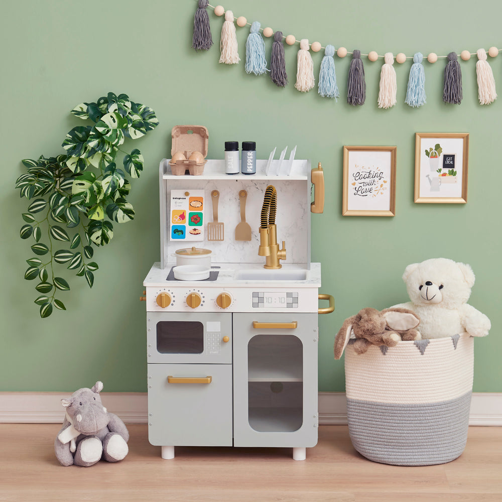 Teamson Kids - Little Chef Memphis Small Play Kitchen - Gray/Gold setup with toys and decorations in a room.