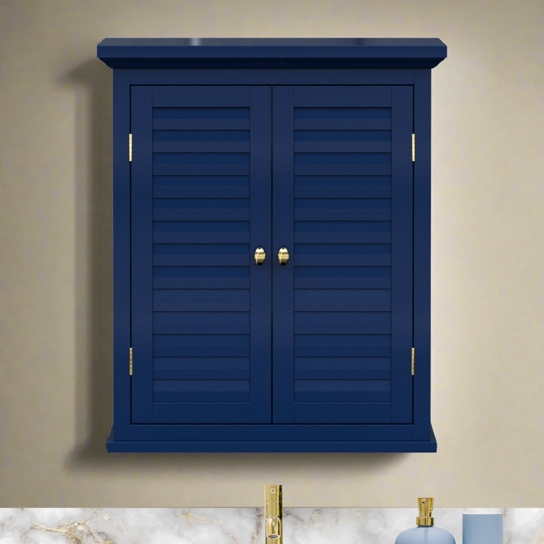 Navy blue wall cabinet with two faux louvered doors and gold hardware on a tan wall over a sink.