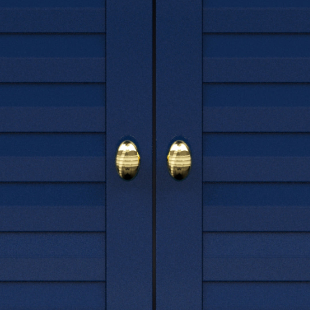 Close-up of gold knobs on navy blue cabinet doors.