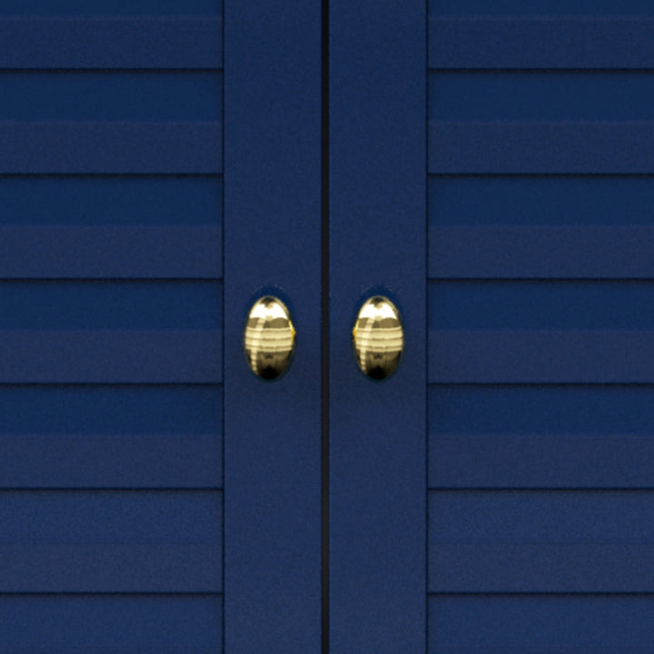 Close-up of gold knobs on navy blue cabinet doors.