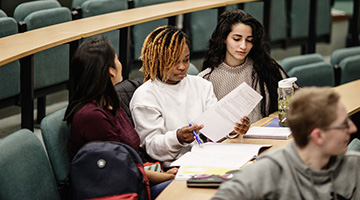 Image for Students reading notes in a lecture hall