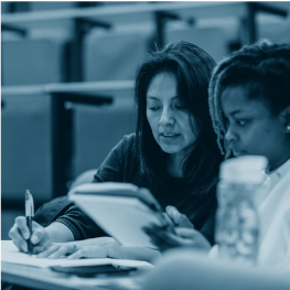 female staff member helping student in lecture