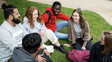 Image for Undergraduate students of tourism & hospitality courses sitting on the grass chatting