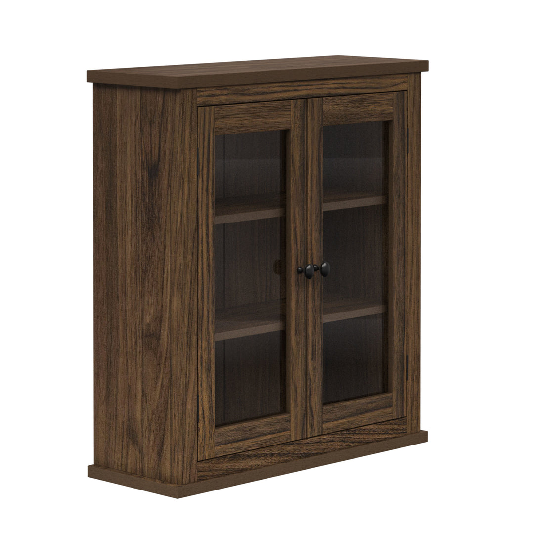 Side view of a walnut-finished two-door wall cabinet with glass panels.