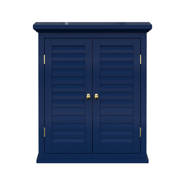 Navy blue wall cabinet with two faux louvered doors and gold hardware.